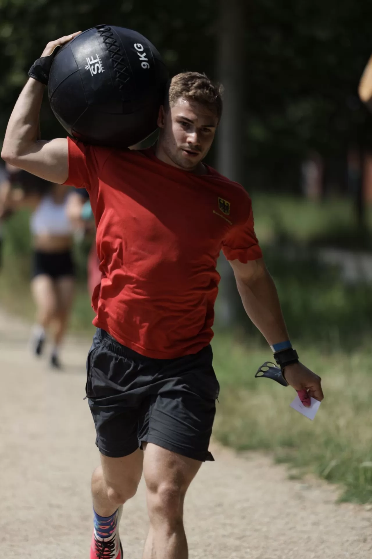 Lauf mit dem Medizinball auf der Schulter im Outdoor-Training